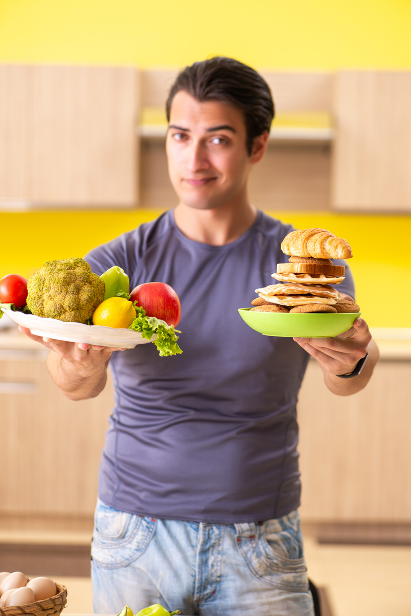 Man Having Hard Choice between Healthy and Unhealthy Food